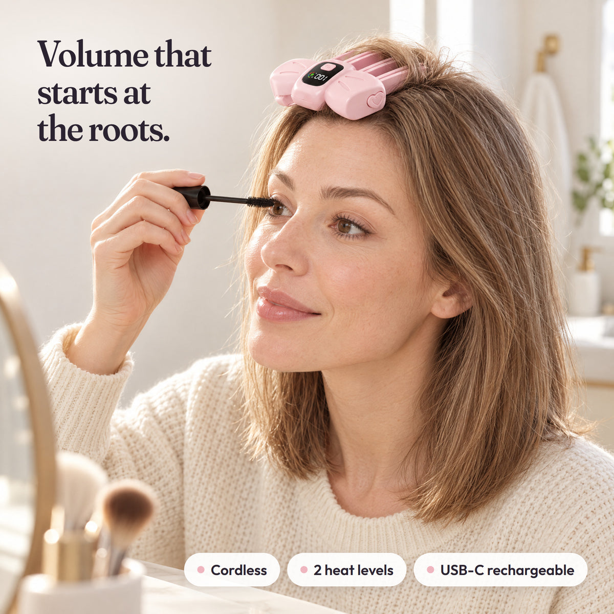 Pink AirTuft root clip placed at the roots during a makeup routine