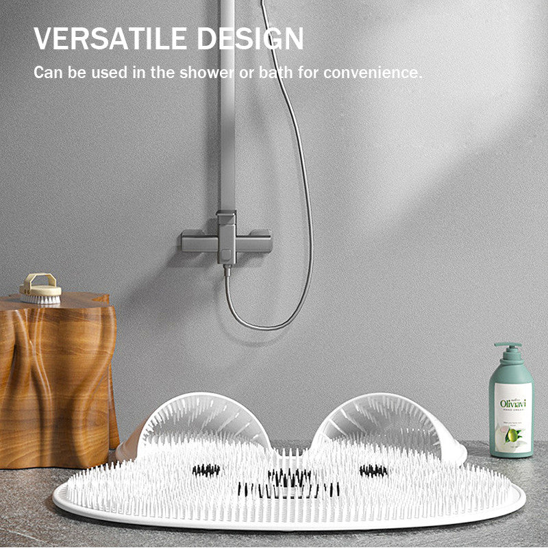 White ToeRub foot scrubber mat shown beside a shower and bath items